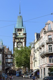 Germany, Baden-Wurttemberg, Freiburg im Breisgau, tram on the street Kaiser-Joseph Strasse and the Martinstor one of the original city gates in the background