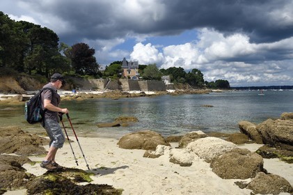 France, Finistere (29), Fouesnant, hiker on the coastline walkway between Cap Coz and the Pointe de Beg Meil