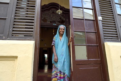 Sri Lanka, Southern Province, Galle Fort, listed as World heritage by UNESCO, old lady in front of her colonial style house