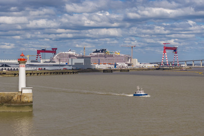 France, Loire-Atlantique, Saint-Nazaire, the Vieux Mole lighthouse and the 333m MSC World America cruise ship built by Chantiers de l'Atlantique in the background (aerial view)