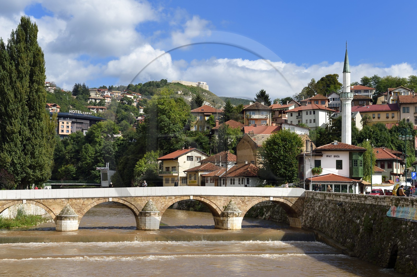 Bosnia and Herzegovina, Sarajevo, the Seher Cehaja bridge over the Miljacka River and the House of Spite (Inat Kuca) on the right underneath the minaret