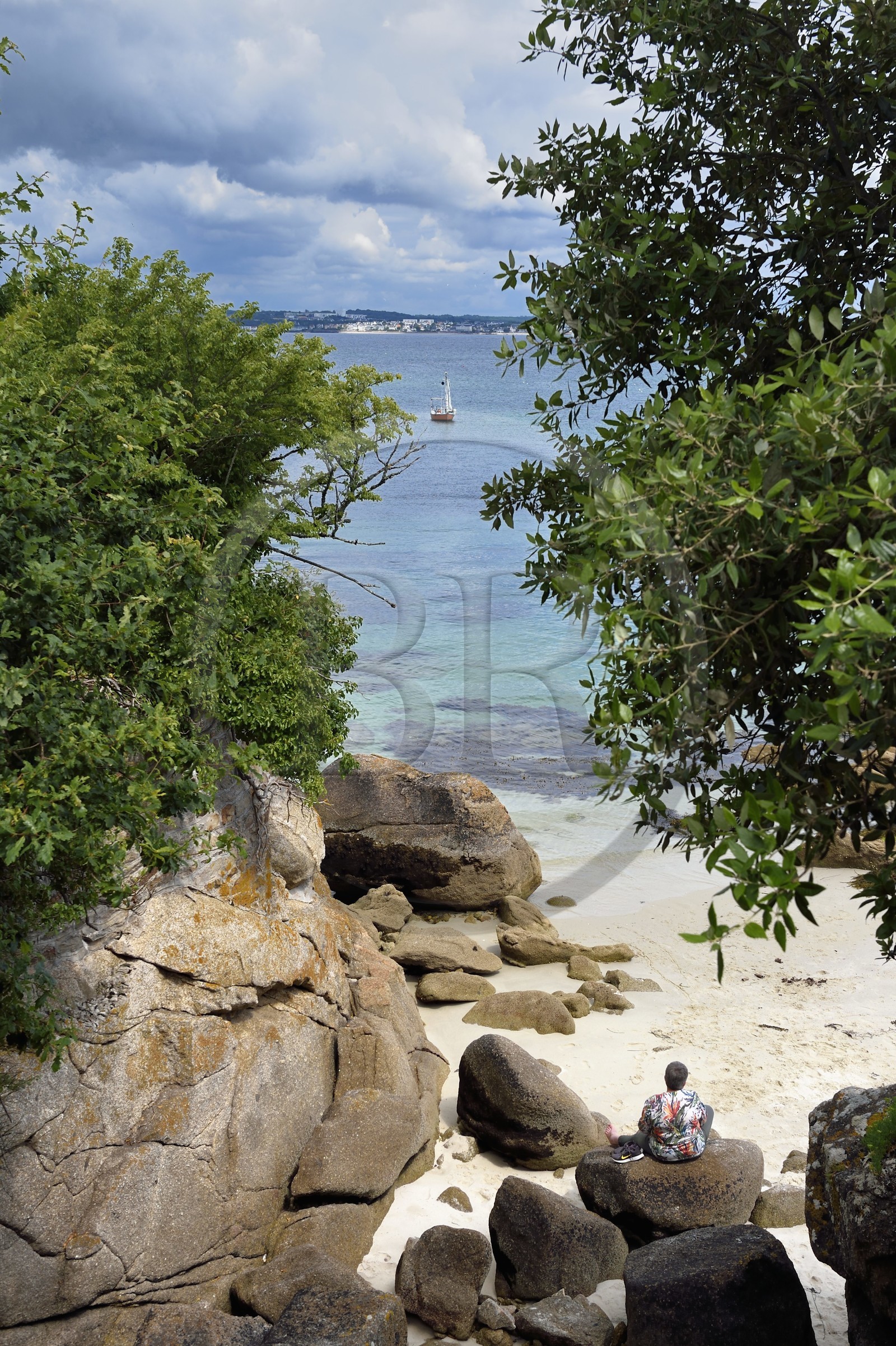 France, Finistere (29), Fouesnant, the coastline between Cap Coz and the Pointe de Beg Meil, meditation on a rock facing the sea