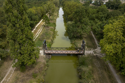 France, Charente Maritime, Echillais, cyclist crossing the lifting footbridge which spans the Charente-Seudre canal (Bridoire canal) (aerial view)