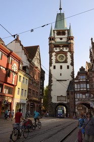Germany, Baden-Wurttemberg, Freiburg im Breisgau, tram on the street Kaiser-Joseph Strasse and the Martinstor one of the original city gates in the background