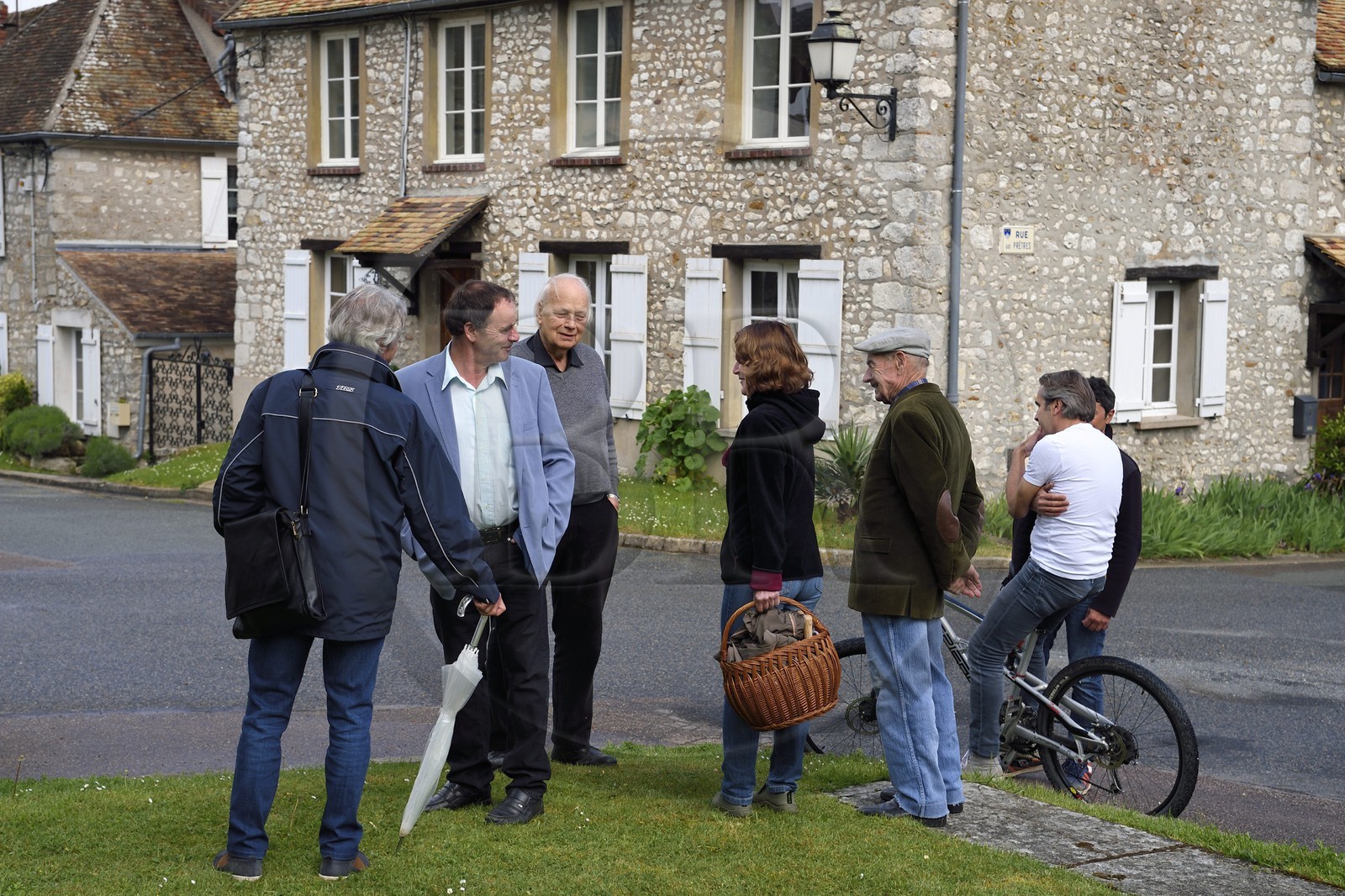 France, Yvelines, Montchauvet, Mayor Georges Duval (in blue jacket) with his citizens on place de l'église
