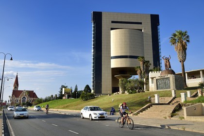Namibia, Khomas region, Windhoek, Christ Church (or Christuskirche), Lutheran church designed by architect Gottlieb Redecker and the Independence Memorial Museum built by North Korea, the Alte Feste (Old Fortress) on the right with the Liberation statue Their Blood Waters Our Freedom