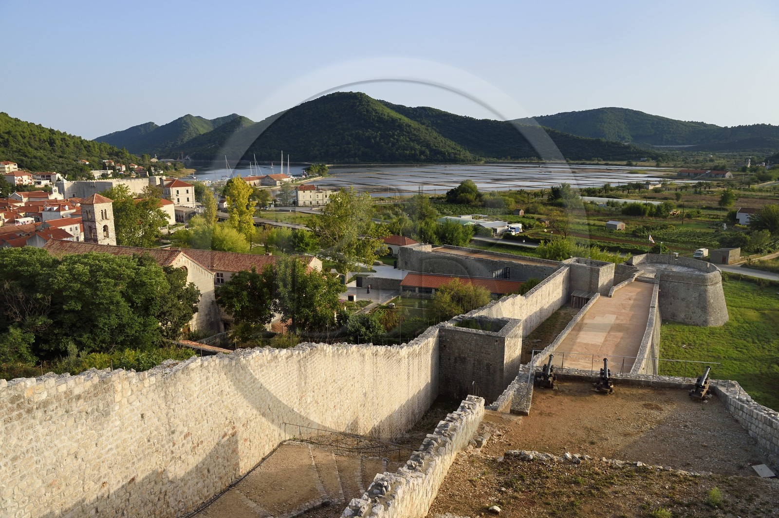 Croatia, Dalmatia, peninsula of Peljesac, the old town of Ston, the ramparts, the Saint-Nicolas monastery on the left and the salt marshes in the background