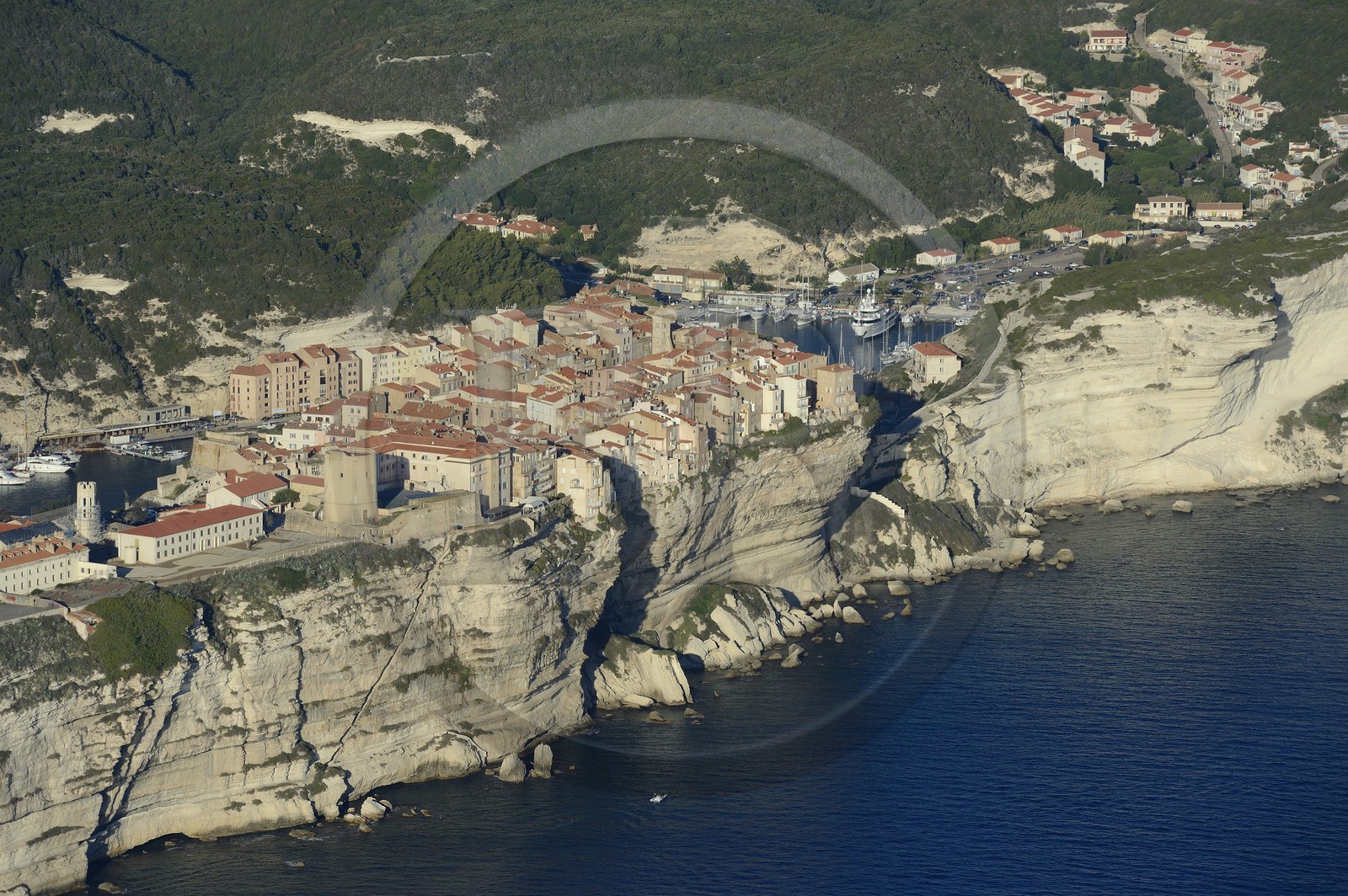 France, Corse du Sud, Bonifacio, the limestone cliffs with the staircase of the King of Aragon, the citadel and the old town (aerial view)