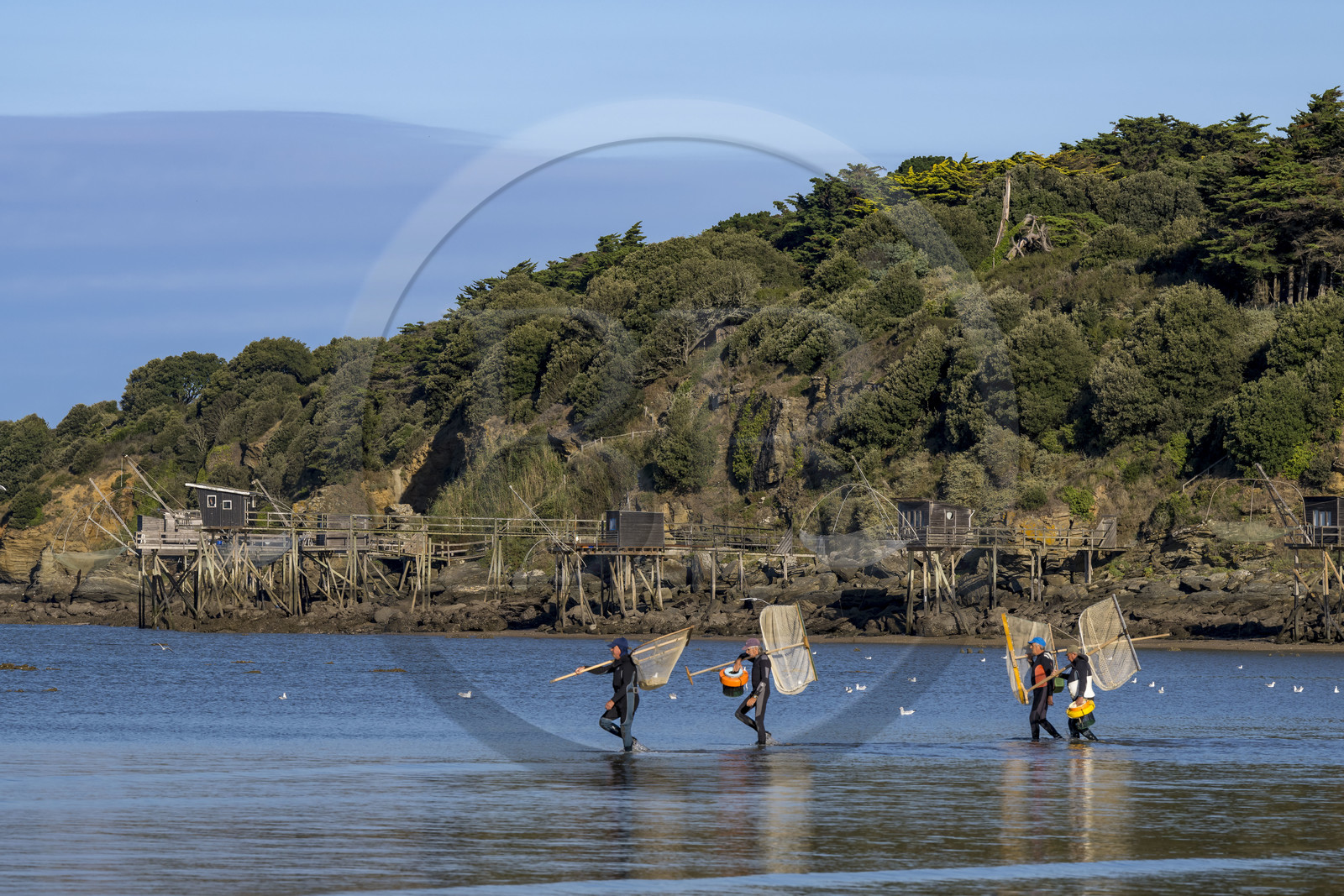 France, Loire Atlantique, Bay of Bourgneuf, Pornic, traditional carrelet (fishing shack) in fishing huts on the edge of Creve-coeur beach at La Bernerie-en-Retz, shrimp fishermen on foot with net