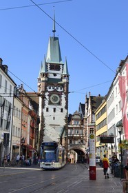 Germany, Baden-Wurttemberg, Freiburg im Breisgau, tram on the street Kaiser-Joseph Strasse and the Martinstor one of the original city gates in the background