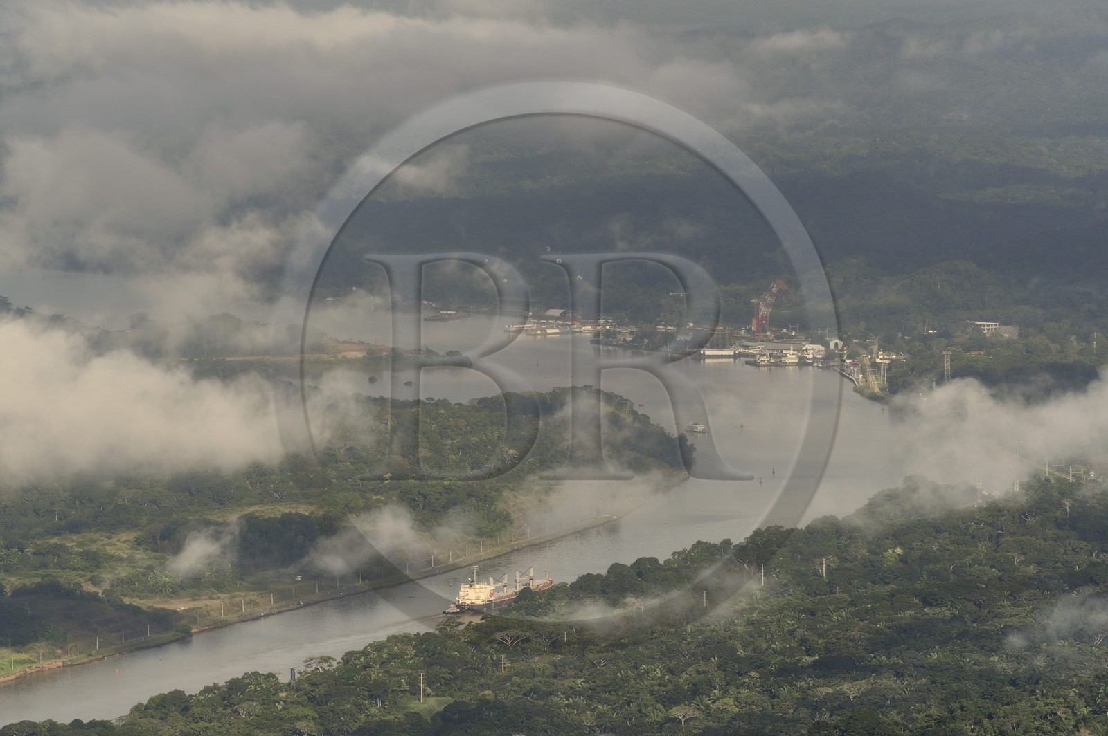 Panama, Panama Canal at Gamboa, Panamax container cargo in the Gaillard cut (or Culebra cut) and the Titan crane built by Nazi Germany in the background right (aerial view)