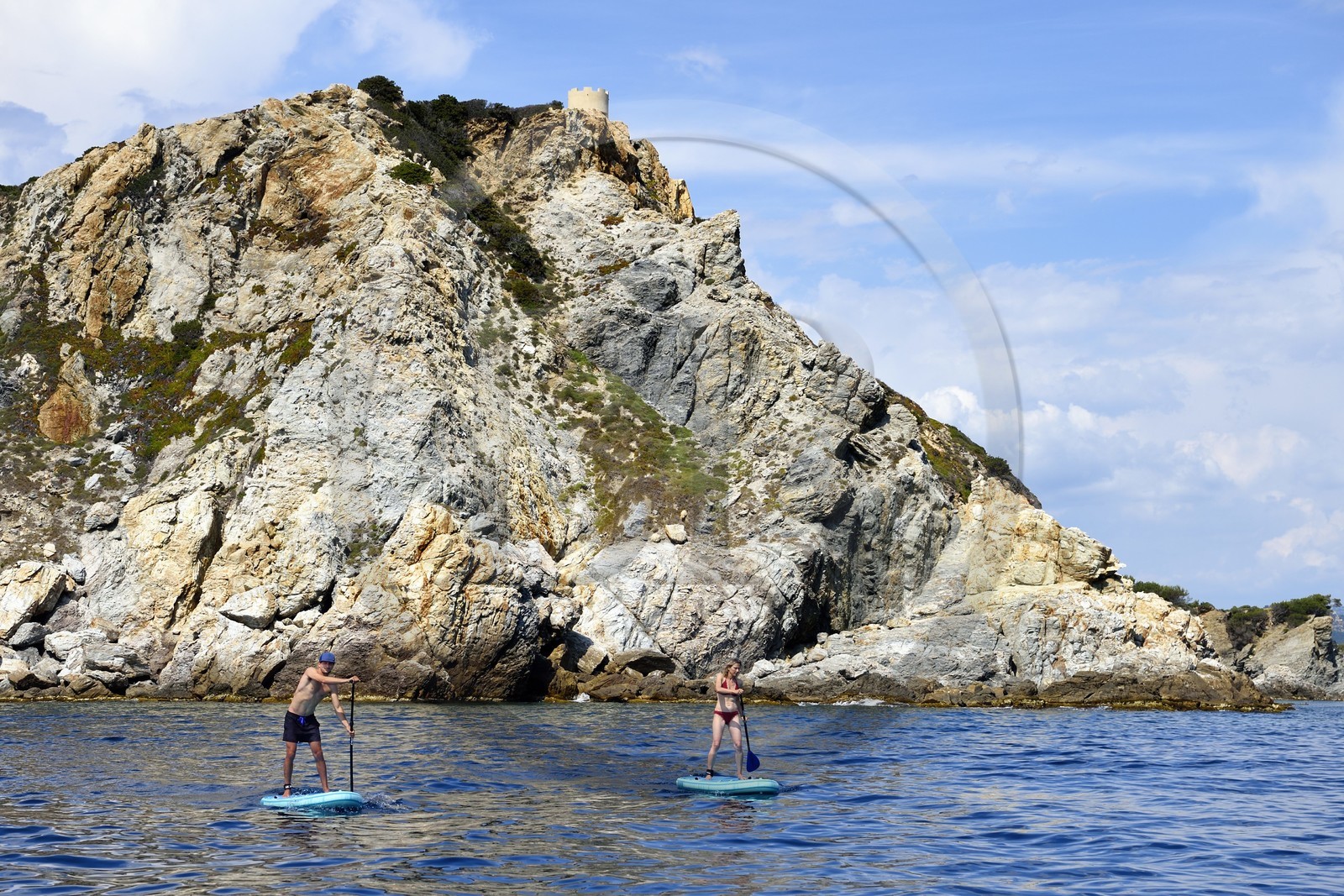 France, Var, Six Fours les Plages, Ile des Embiez, Pointe du Coucoussa overlooked by the Tour de la Marine, Freestyle windsurfing champion Adrien Bosson on a paddle boarding excursion