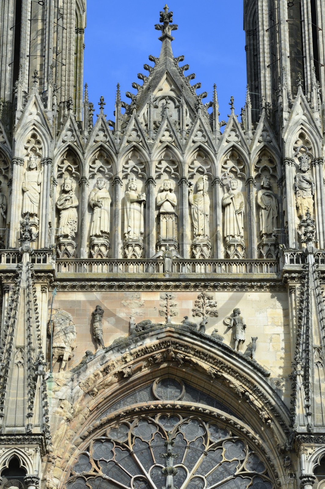 France, Marne, Reims, Notre-Dame de Reims cathedral, listed as World Heritage by UNESCO, the western facade, Baptism of Clovis (center) by the Bishop Saint Remi, in the presence of Clotilde, his wife and inspiration of his conversion, the Bishop assistants and of the hermit Montan