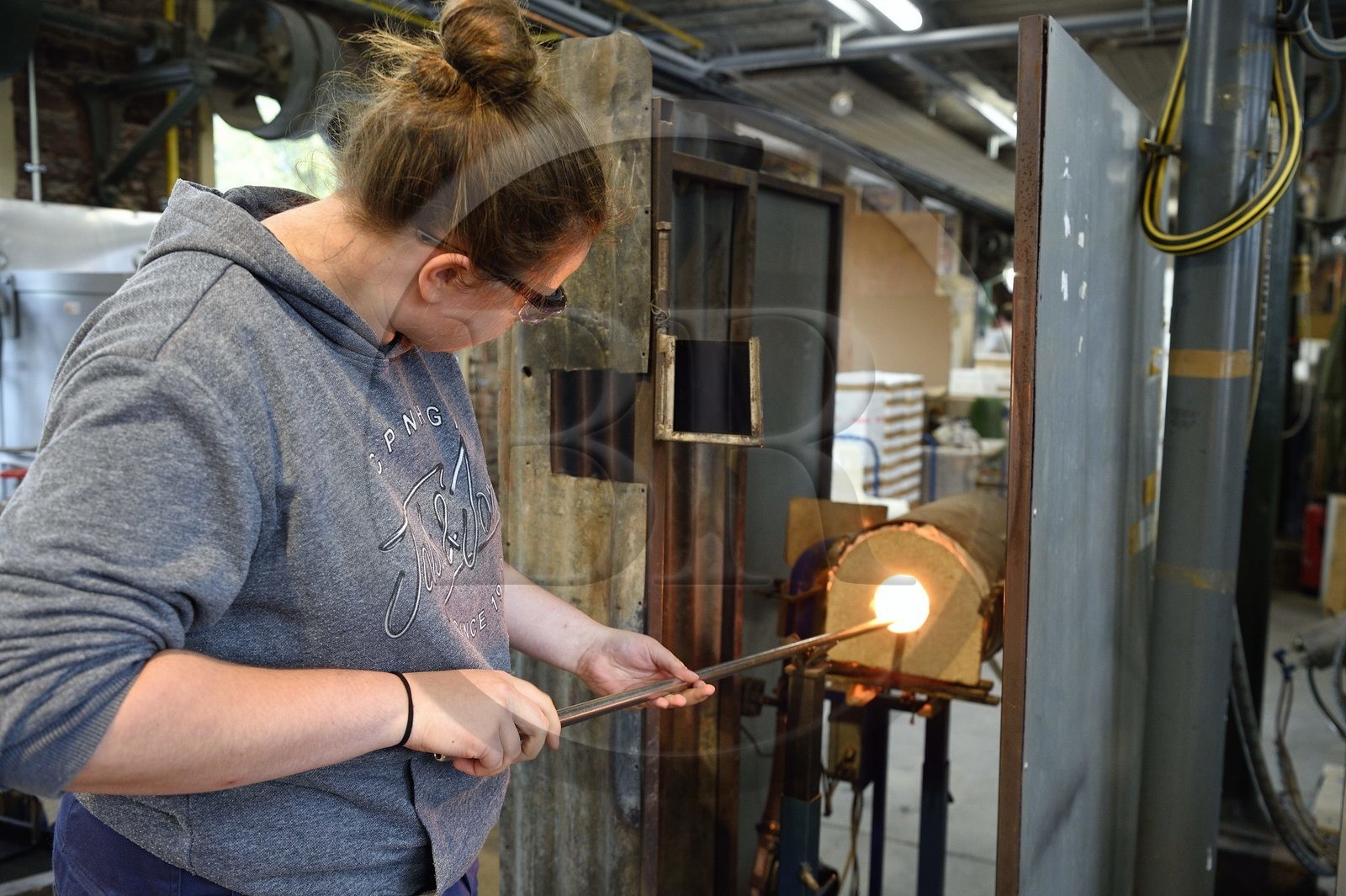 France, Moselle, Meisenthal, Centre international d'Art verrier (CIAV) (international glass centre), the blowing workshop, crafting a Christmas ball, the blower collects a mass of molten glass from the furnace, with his glassmaker's cane