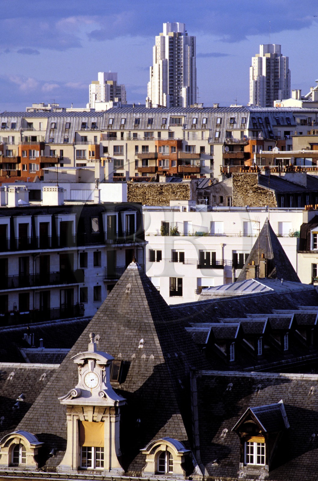France, Paris, old roofs of the Saint Louis Hospital and the modern towers of the Flandre Street in the 19th district