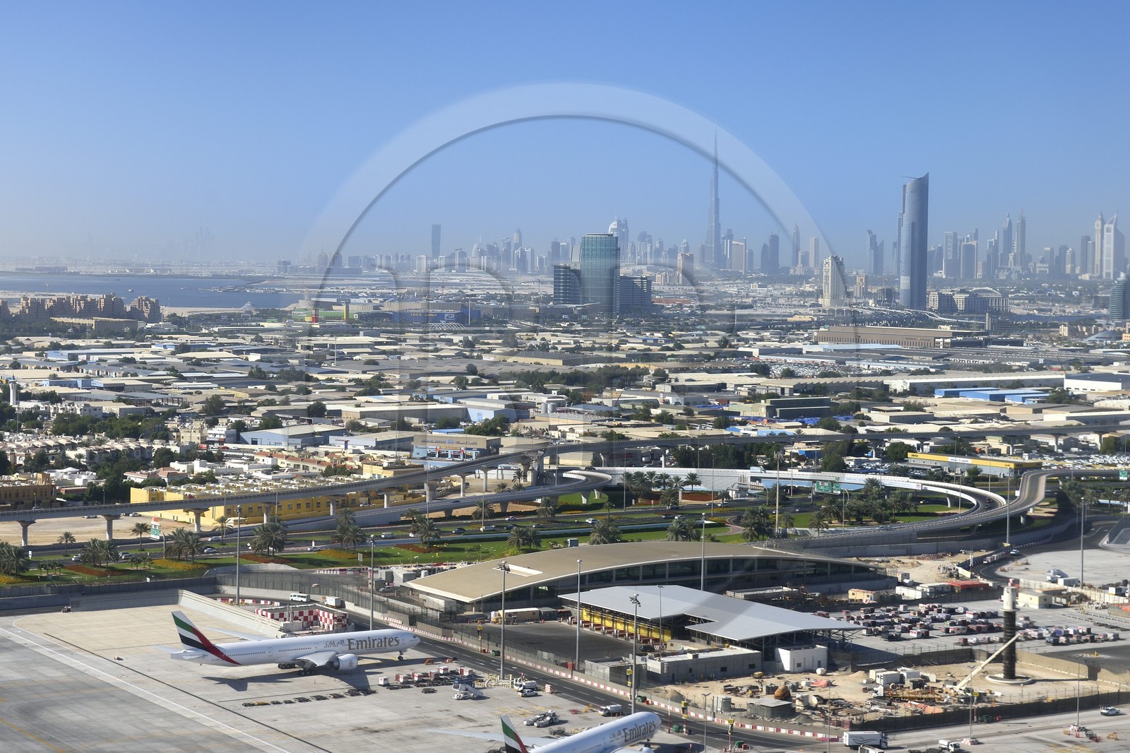 United Arab Emirates, Dubai, Dubai International Airport and the city center in the background (aerial view)