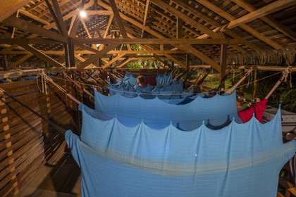 France, French Guiana, Kourou, the carbet (shelter) at Camp Maripas on the banks of the Kourou river, hammocks suspended under the rafters