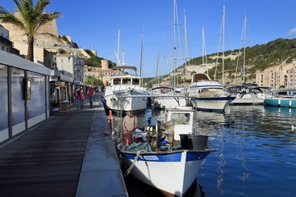 France, Corse du Sud, Bonifacio, the port overlooked by the Citadel in the upper town, fisherman boat