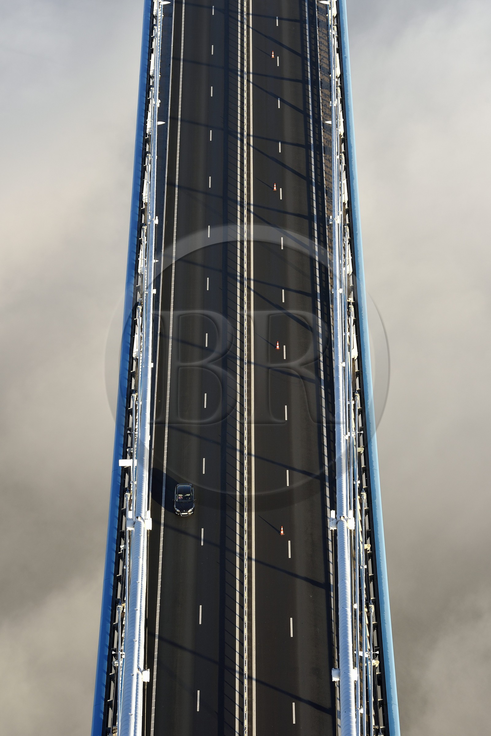 France, between  Calvados and Seine Maritime, the Pont de Normandie (Normandy Bridge) that emerges from the morning mist of autumn and spans the Seine, view from the top of the south pylon