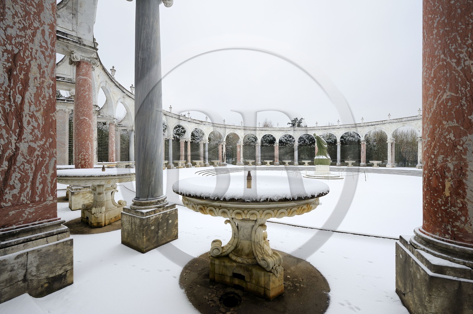 France, Yvelines, snow covered park of the Chateau de Versailles, listed as World Heritage by UNESCO, Bosquet de la Colonade, round peristyle by Mansart
