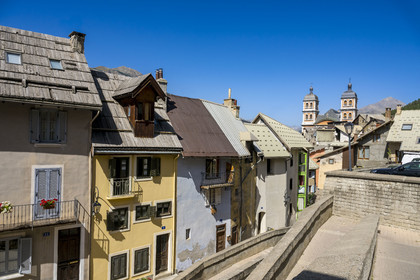 France, Hautes Alpes, Briancon, Vauban site listed as UNESCO World Heritage, the houses on Rue de la Manutention within the citadel and the bell towers of the Notre-Dame-et-Saint-Nicolas collegiate church in the background