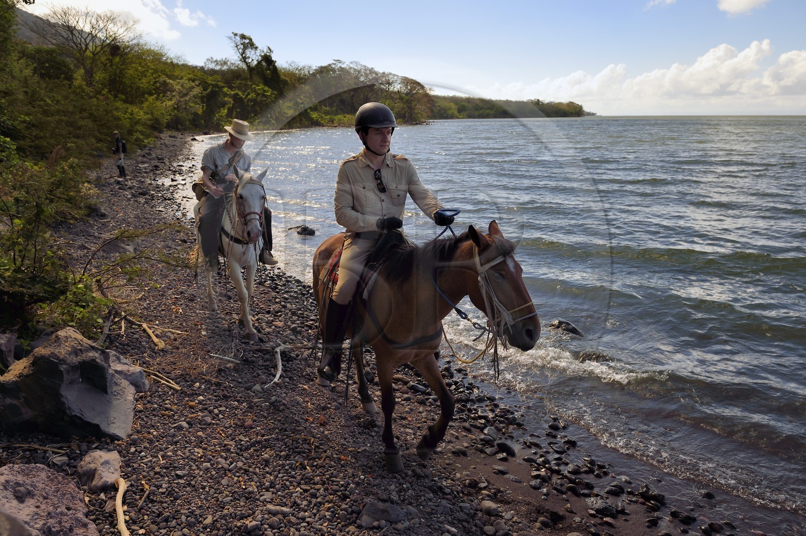 Nicaragua, Ometepe Island in Lake Nicaragua, riders along the lake