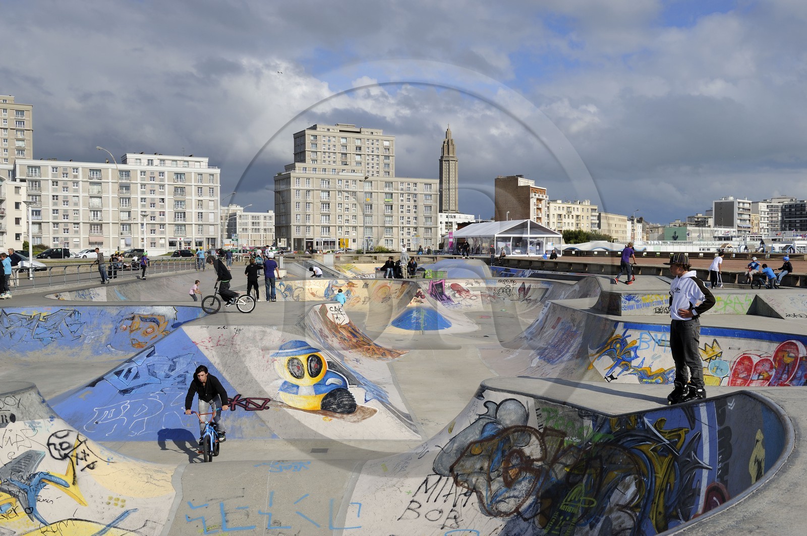 France, Seine Maritime, Le Havre, Downtown rebuilt by Auguste Perret listed as World Heritage by UNESCO, the Skate park on the beach, Perret buildings of Porte Océane (Ocean Gate) and St. Joseph's Church in the background