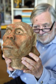 France, Paris, the french paleontologist and paleoanthropologist Yves Coppens, professor at the College de France, in the office of his home in Paris, he holds in his hand the supposed reproduction of Lucy's face