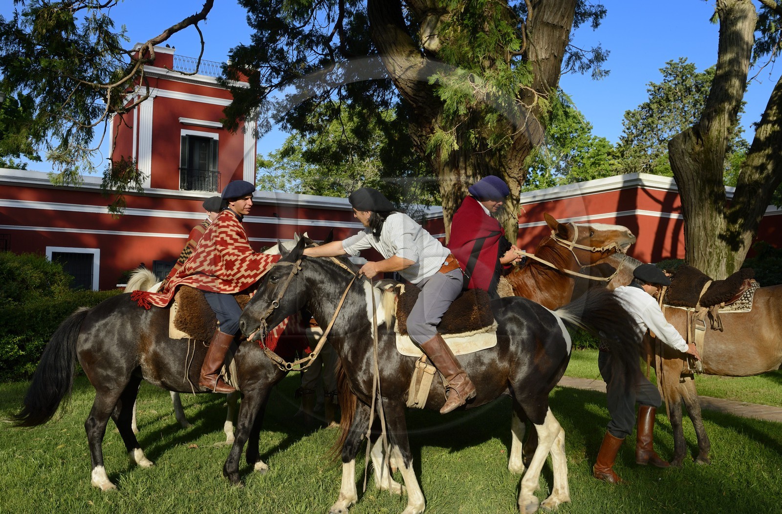 Argentina, Buenos Aires Province, San Antonio de Areco, group of gauchos on horseback in front of the estancia La Bamba de Areco