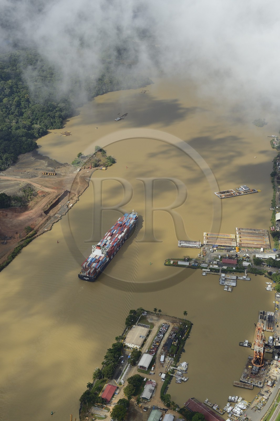 Panama, Panama Canal at Gamboa, Panamax container cargo and the Titan crane built by Nazi Germany on the right (aerial view)