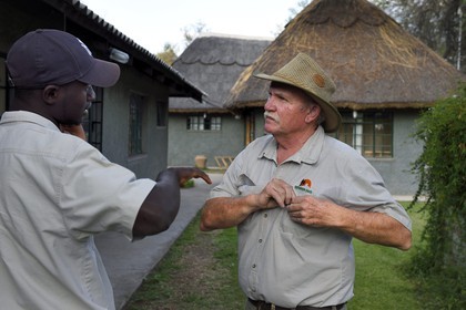 Zimbabwe, Midlands Province, Gweru, Antelope Park home to ALERT (African Lion and Environmental Research Trust), the managing director Gary Jones on the right and the guide Ngaa