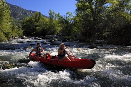 France, Herault, Orb valley, kayaking the river Orb at the moulin de Travassac next to Mons la Trivalle, the mount Caroux in the back