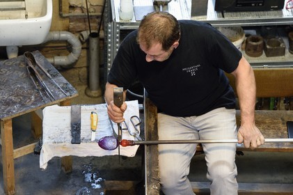 France, Moselle, Meisenthal, Centre international d'Art verrier (CIAV) (international glass centre), the blowing workshop, crafting a Christmas ball, shaping at the outlet of the blow mold by the master glassmaker Jean-Marc Schilt