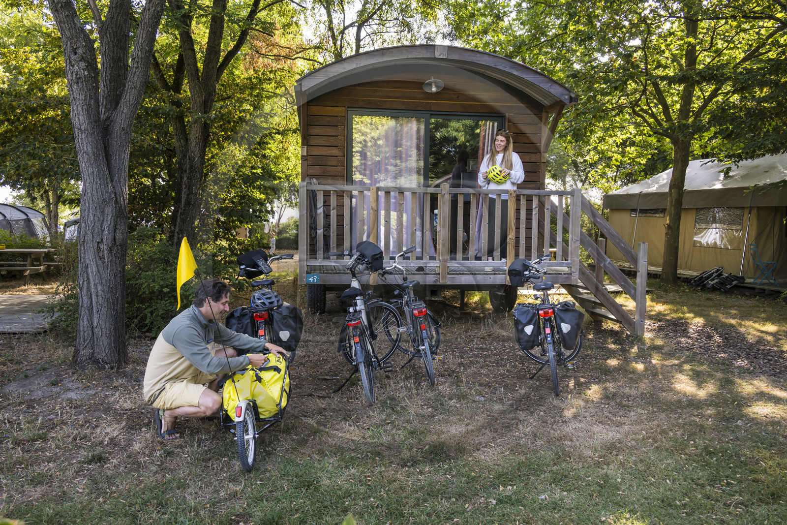 France, Maine-et-Loire, Loire valley listed as World Heritage by UNESCO, Saumur towards Saint-Hilaire, Camping Huttopia Saumur, cycling on the banks of the Loire and installation in a trailer, bike with a trailer carrying camping equipment