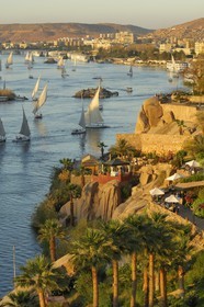 Egypt, Upper Egypt, Nubia, Nile Valley, Aswan, felucca and cruise ship on the Nil at Old Cataract Hotel, the port in the background