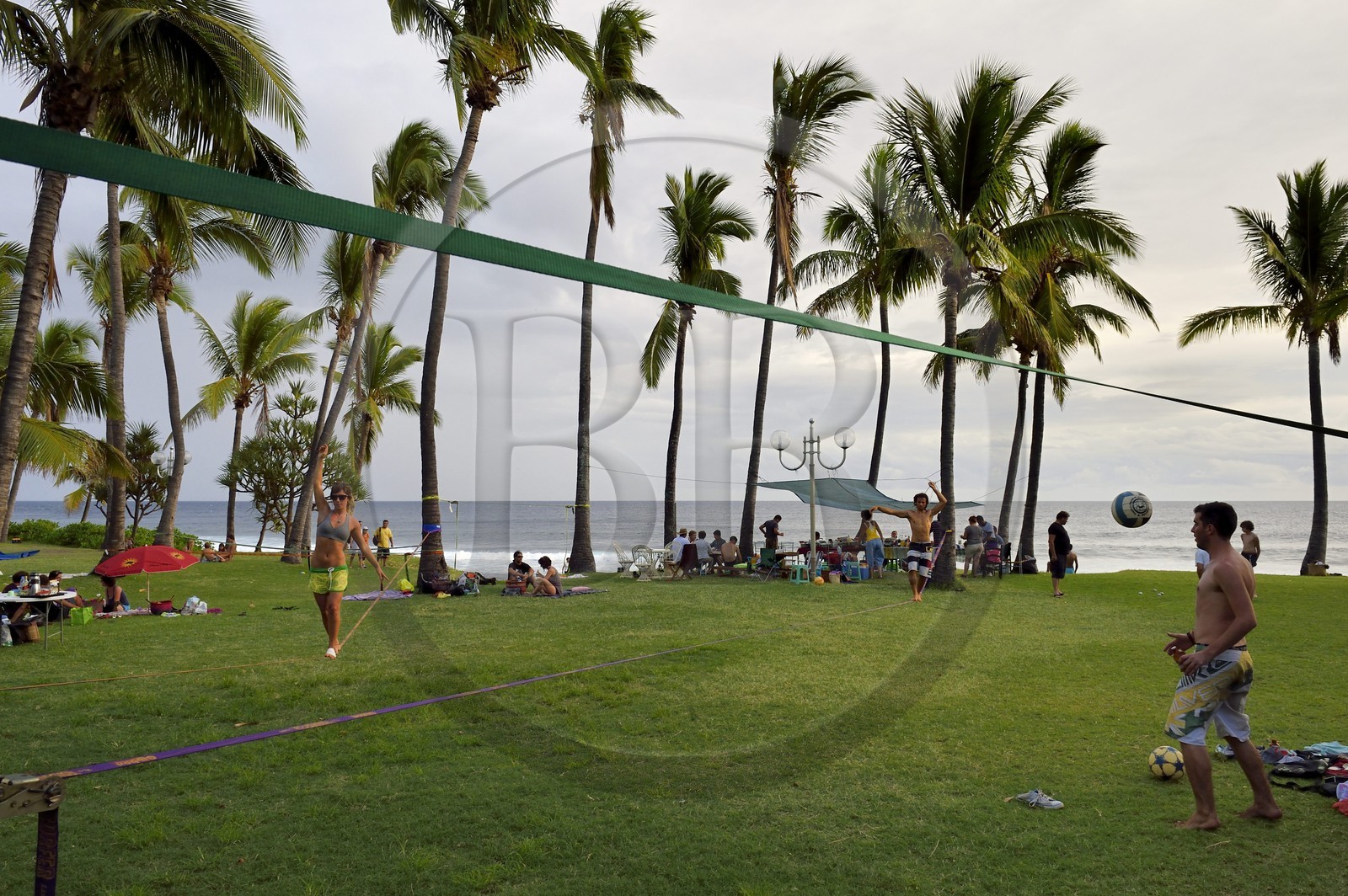 France, Reunion island (French overseas department), southern coast, Grande Anse beach, the beach is very popular weekends by Creole families for recreation and picnic, Slackline slack (the goal is to move to a slightly elastic strap without any accessories)