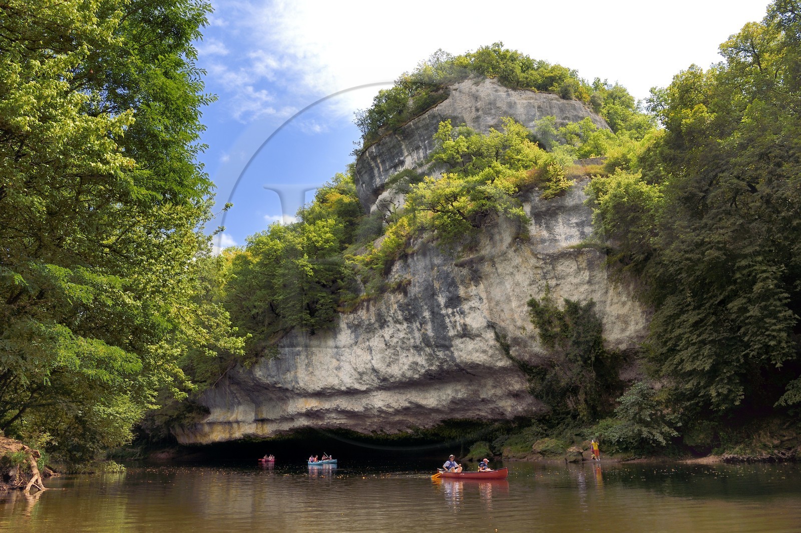 France, Dordogne, Perigord Noir, Vezere Valley at Peyzac le Moustier, canoeing on the Vezere river under the Roque Saint-Christophe cliffs