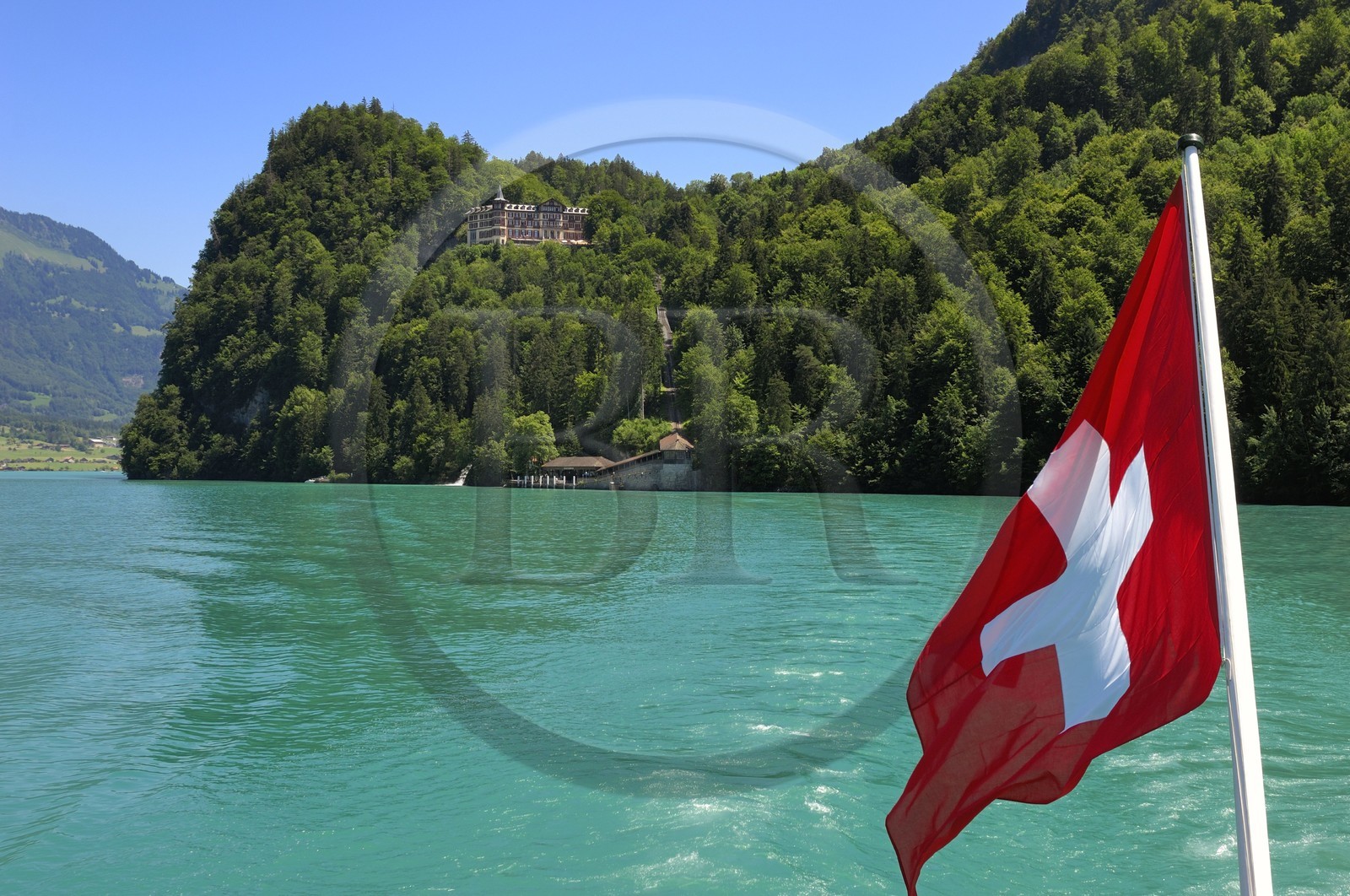 Switzerland, Canton of Bern, Bernese Oberland, Interlaken, Lake Brienz (Brienzer See), Luxury Hotel in Giessbach and swiss flag