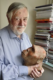 France, Paris, the french paleontologist and paleoanthropologist Yves Coppens, professor at the College de France, in the office of his home in Paris, he holds in his hand the supposed reproduction of Lucy's face